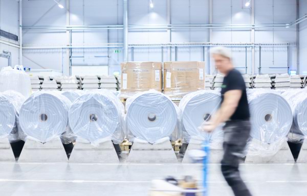 Ecolean employee and film rolls in the warehouse at our production site in Helsingborg, Sweden.